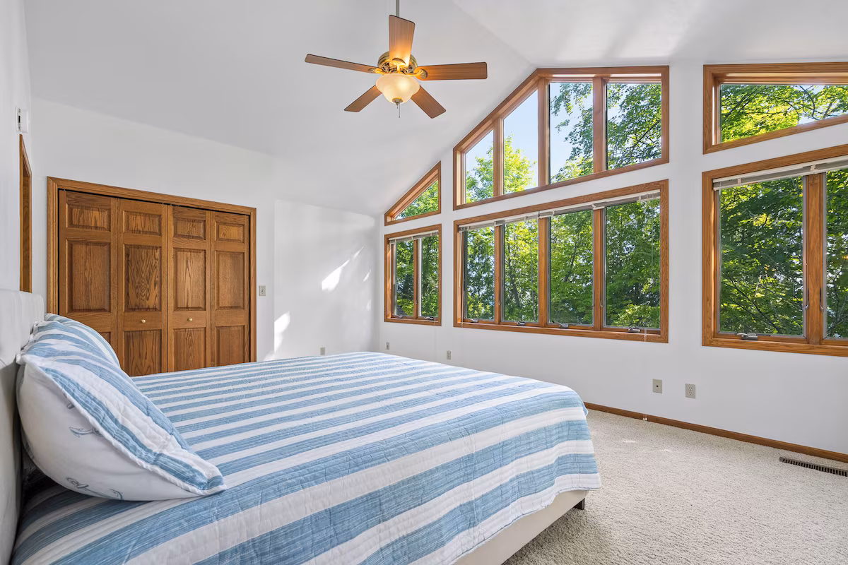Master bedroom with natural light and lake views